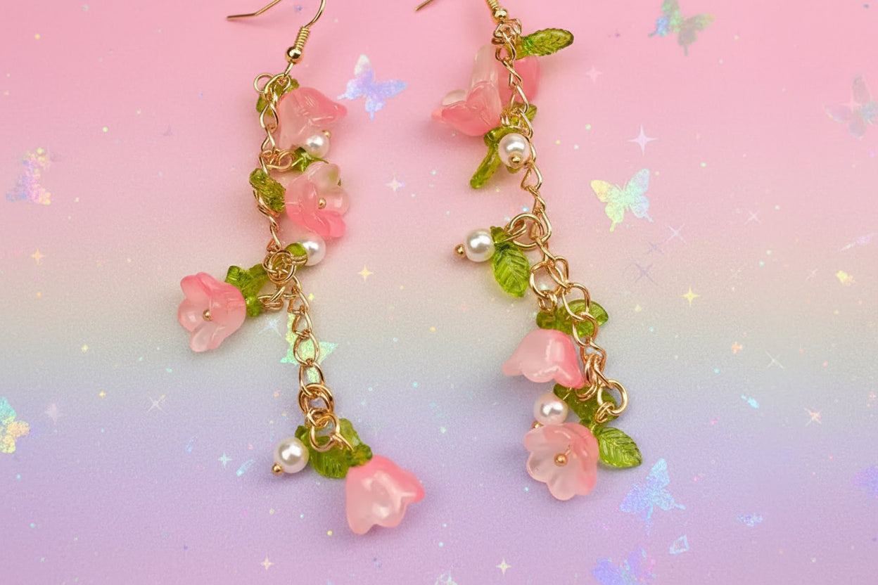 Floral and pearl earrings on a beige fabric background